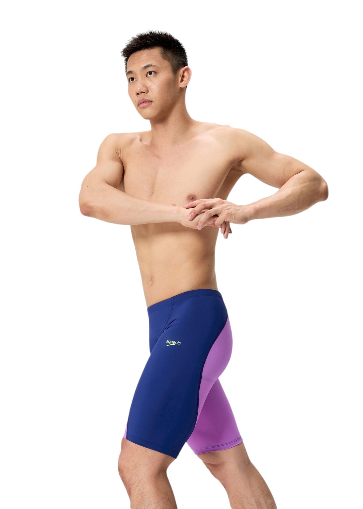 Side profile of  the Speedo Men's Jammer LZR Racer Pro 2.0 - Navy / Purple on a model, showing the full length of the jammer and how the purple panel curves along the back of the leg.
