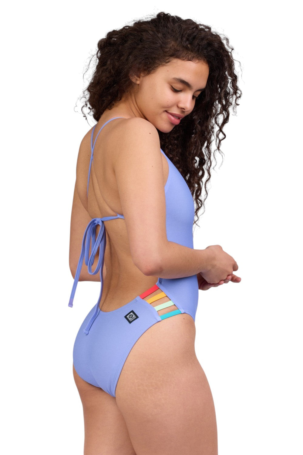 Jolyn women's one-piece training swimsuit Gavin - Lavender contrast. colors: main body Lavender, side straps Strawberry, Mango, Mint & Hawaii Blue - right back view. Collection March 2026